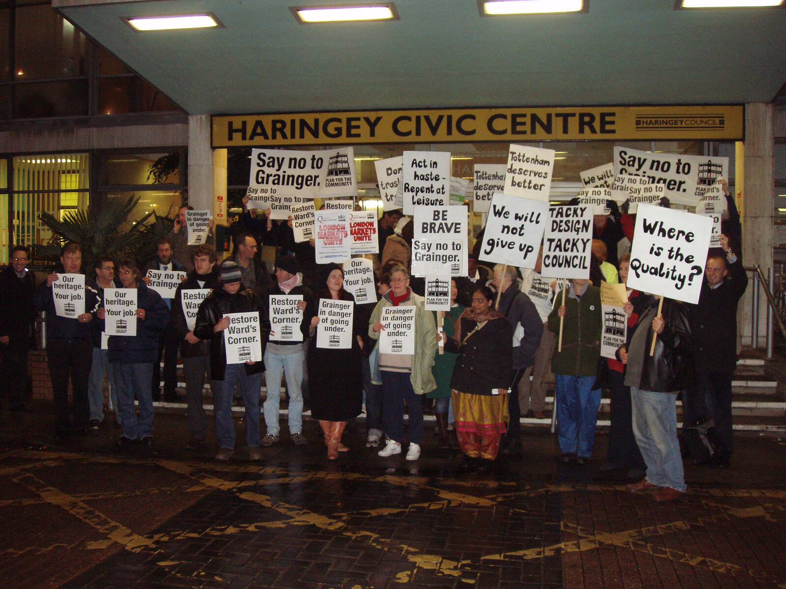A crowd outside Haringey Civic Centre holding "Say no to Grainger" and "Restore Ward's Corner" placards.